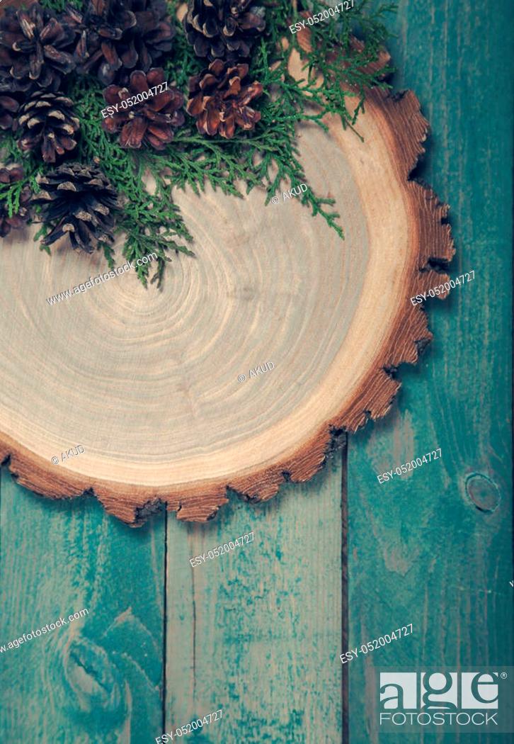 Stock Photo: Wooden board with leaves of thuja and pine cones on blue wooden table.