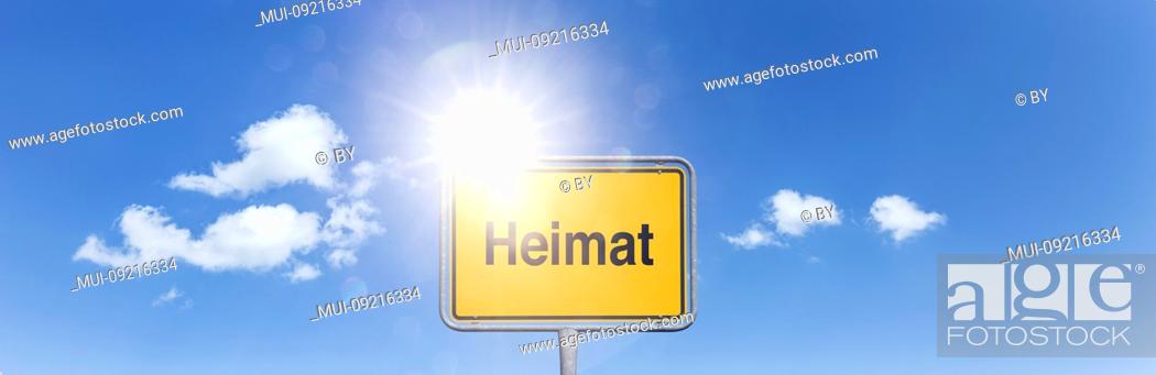 Stock Photo: Shield 'Heimat' in front of sky with white clouds [M].