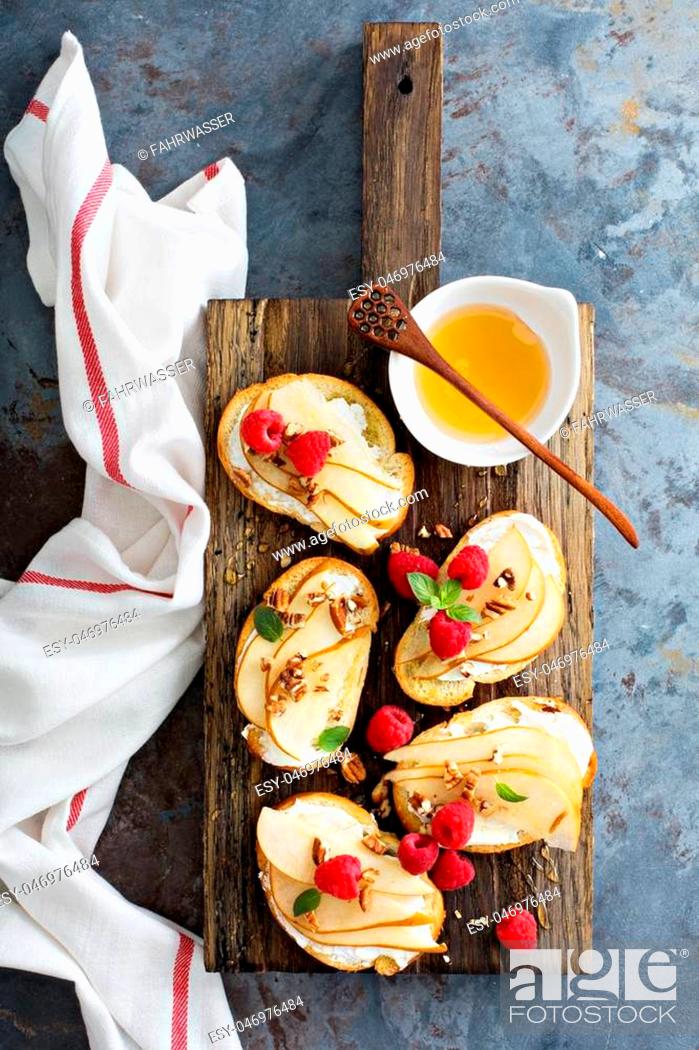 Stock Photo: Pear bruschetta with cream cheese, nuts and honey.