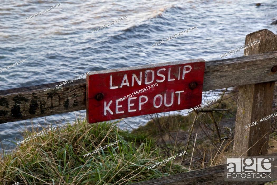 Stock Photo: 'Landslip, Keep Out' warning sign at edge of cliff, Osmington, Dorset, England, January.