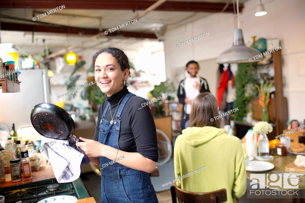 Stock Photo: Portrait smiling young woman doing dishes in apartment.