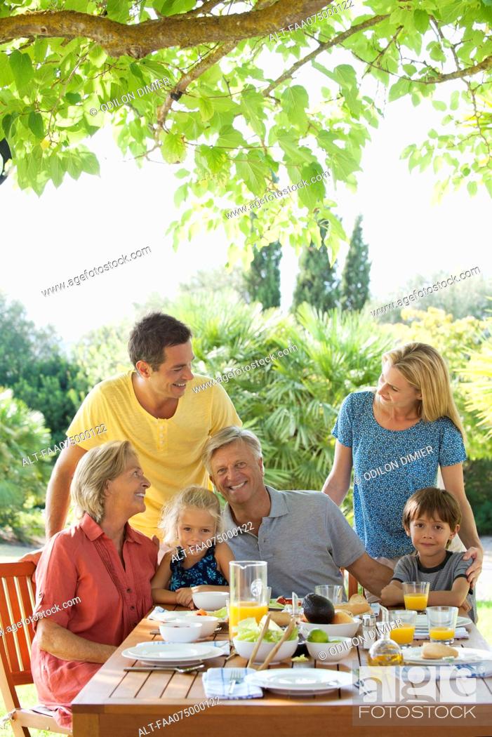Stock Photo: Multi-generation family having breakfast outdoors.