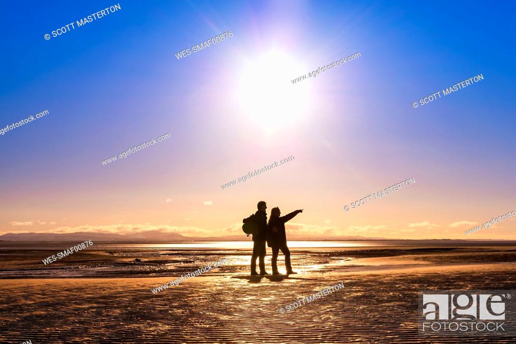 Stock Photo: Great Britain, Scotland, Solway Firth, silhouette of mature couple.