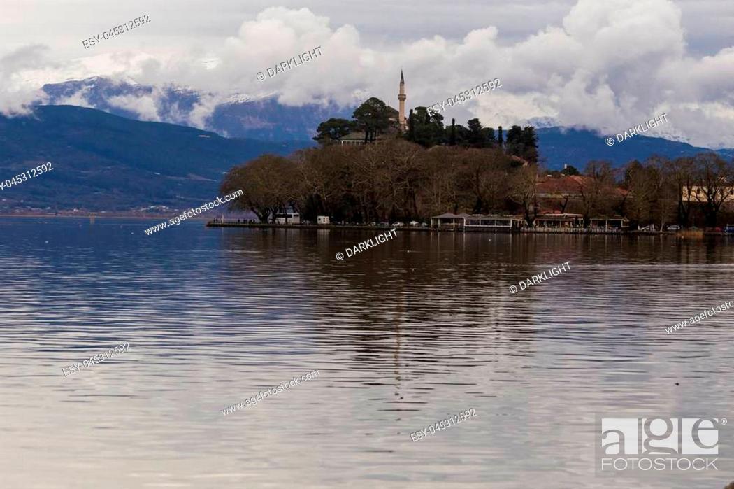Stock Photo: Ioannina lake called ""Pamvotis"" in a winter cloudy foggy day.