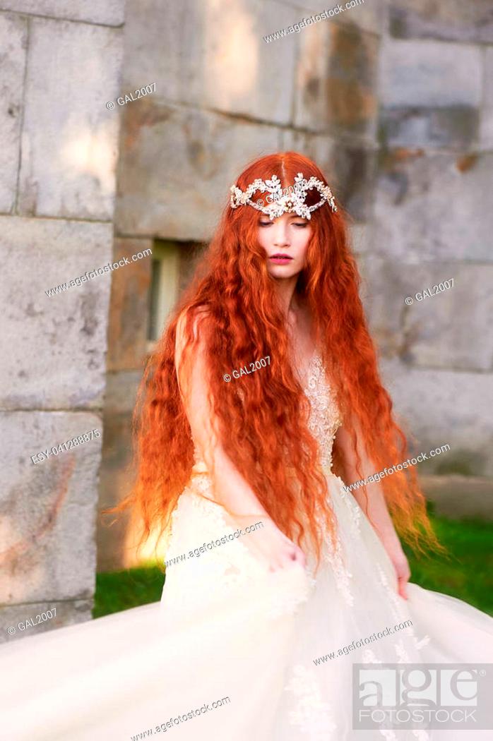 Beautiful red-haired girl with long curly hair in the bride, in a long lace  dress, Stock Photo, Picture And Low Budget Royalty Free Image. Pic.  ESY-041288875 | agefotostock