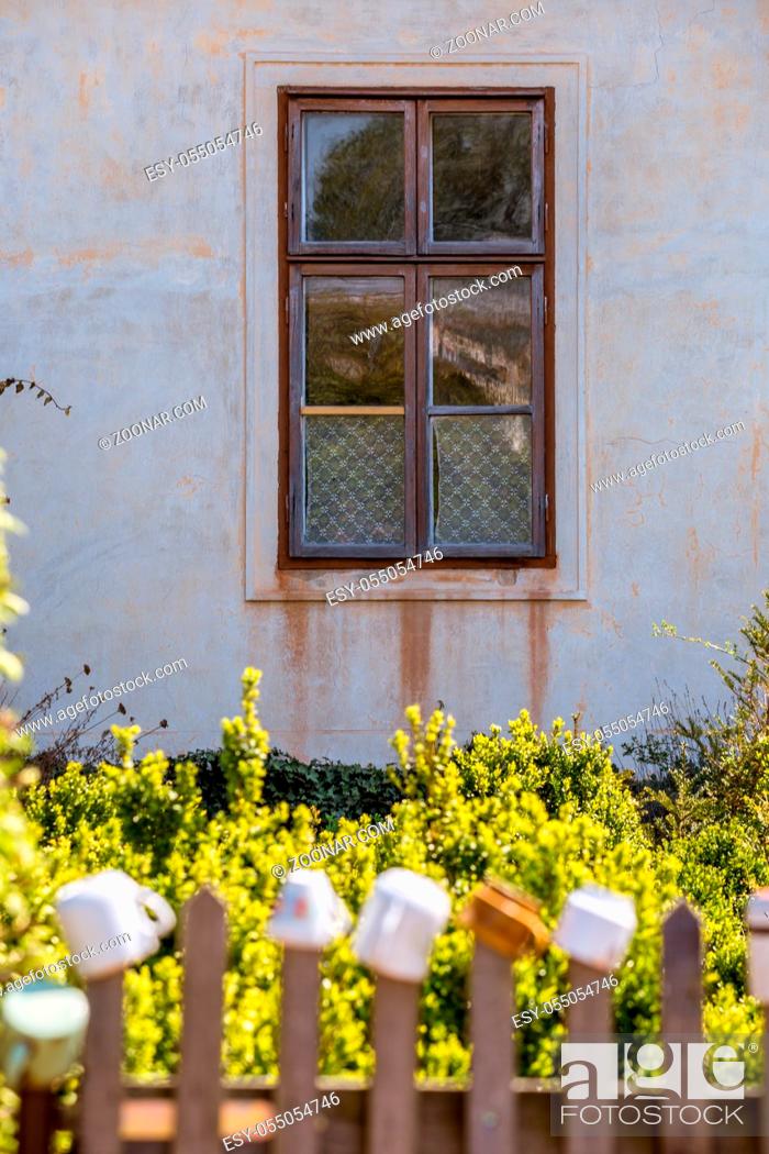 Stock Photo: Old farm building and dwelling house, climbing roses and flowers, picturesque windows and doors it is a romantic corner near Milotice Castle, South Moravia.
