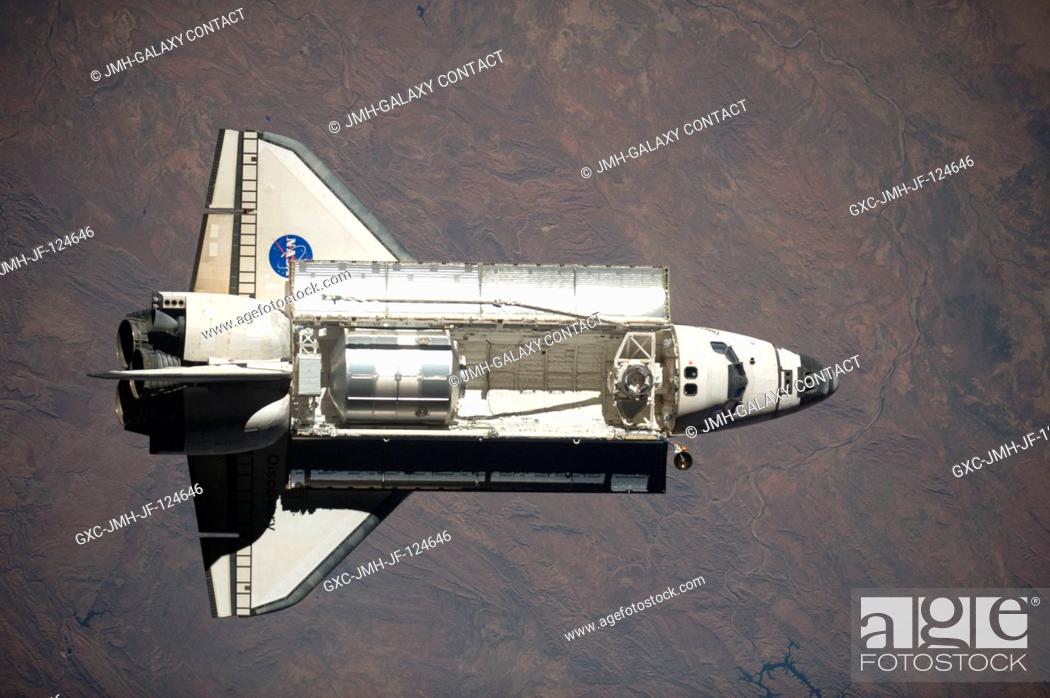 Stock Photo: Space Shuttle Discovery is featured in this image photographed by an Expedition 20 crew member as the shuttle approaches the International Space Station during.