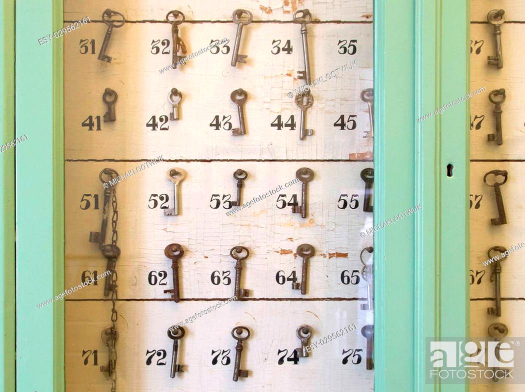 Stock Photo: Vintage keys with numbers hanging in an old closet.
