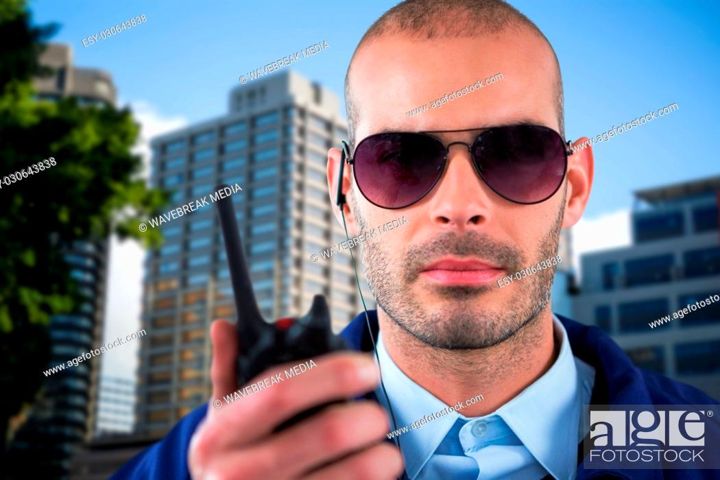 Stock Photo: Composite image of portrait of security officer talking on walkie talkie.