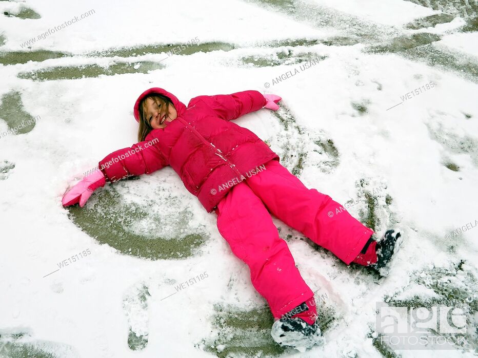 Stock Photo: girl doing a snow angel.