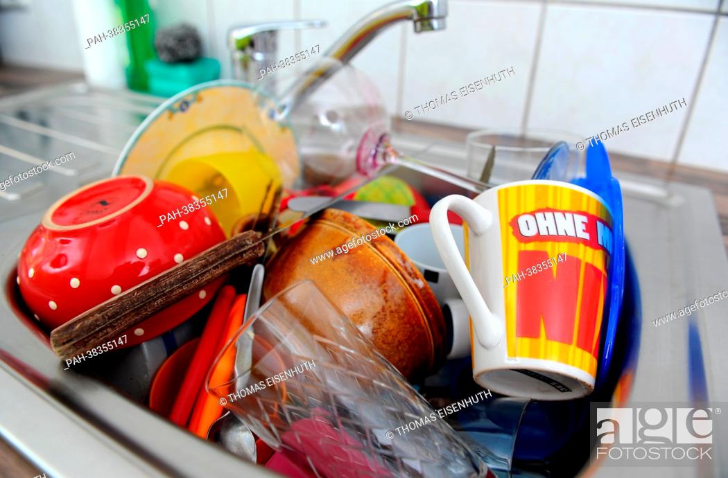 Stock Photo: Dirty dishes are stacked in a sink in Dresden, Germany, 19 March 2013. Photo: Thomas Eisenhuth | usage worldwide. - Dresden/Saxony/Germany.