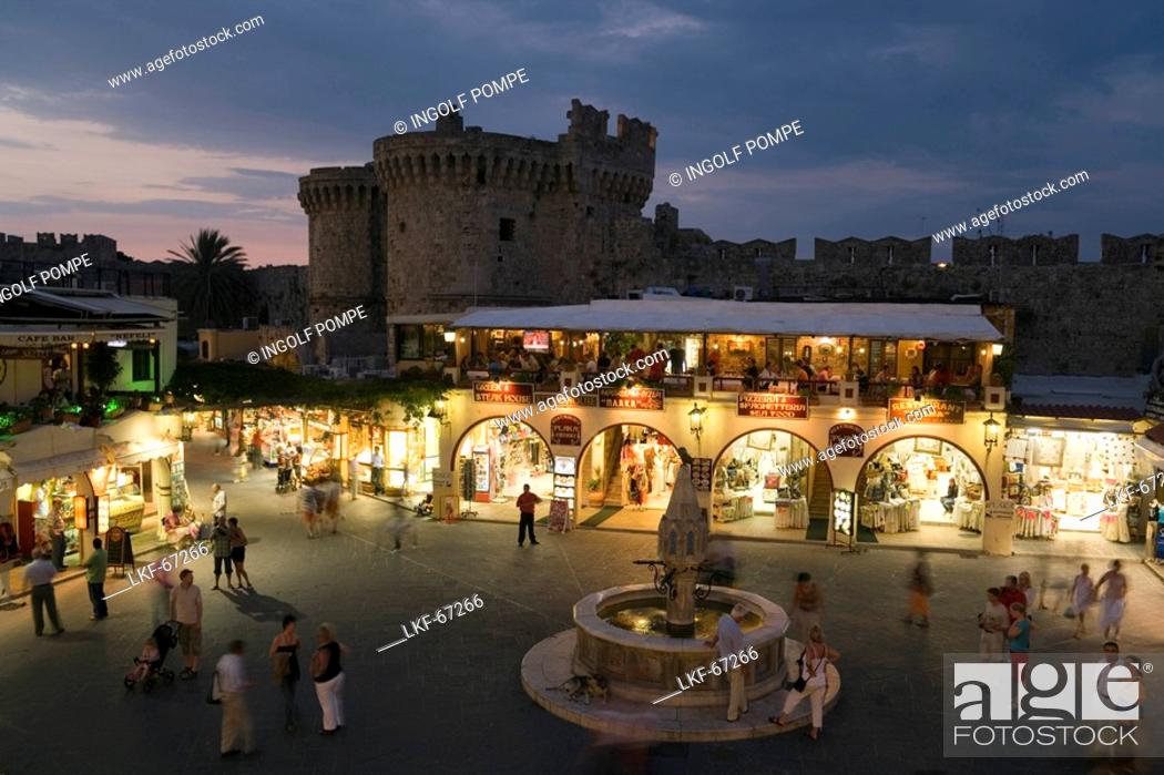 Stock Photo: View over busy Platia Ippokratou with Thalassini Gate in background in the evening, Rhodes Town, Rhodes, Greece, Since 1988 part of the UNESCO World Heritage.