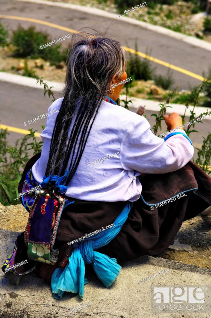 Female pilgrim with traditional hair-style at the Ganden convent (4300m)  near Lhasa, Tibet, Stock Photo, Picture And Rights Managed Image. Pic.  IBR-560401 | agefotostock