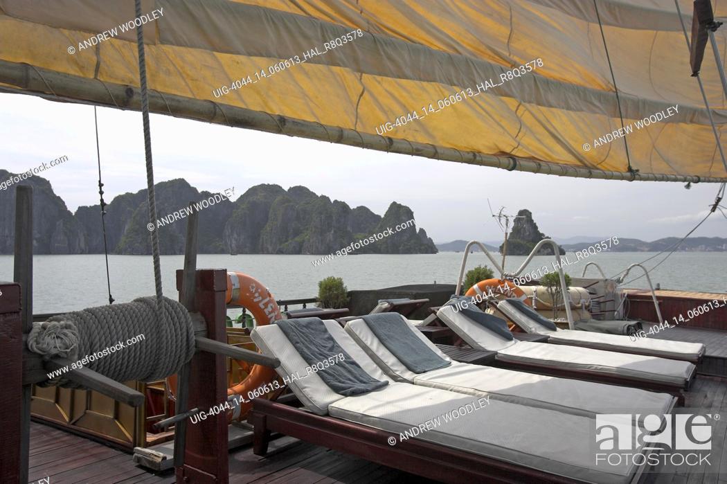 Stock Photo: Large comfortable sailing junk with aft deck sun beds Halong Bay Vietnam.
