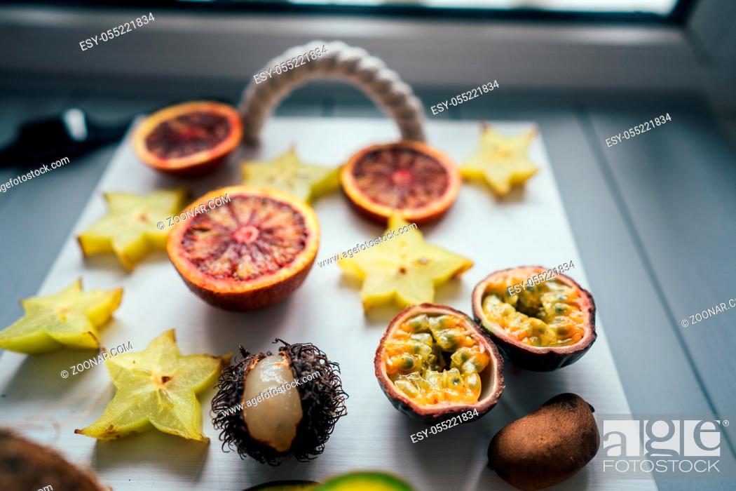 Photo de stock: Exotic fruits on a tray on a light background.