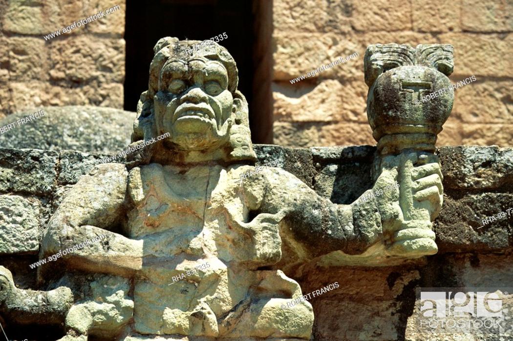 Stock Photo: The Mayan rain god Chac, holding burning torch showing his power to withhold or dispense rain, in west court of the Mayan ruins at Copan.