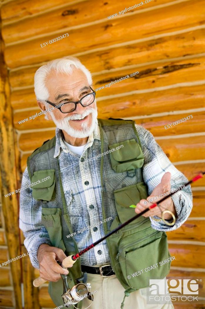 Stock Photo: Middle-aged man holding fishing rod smiling.