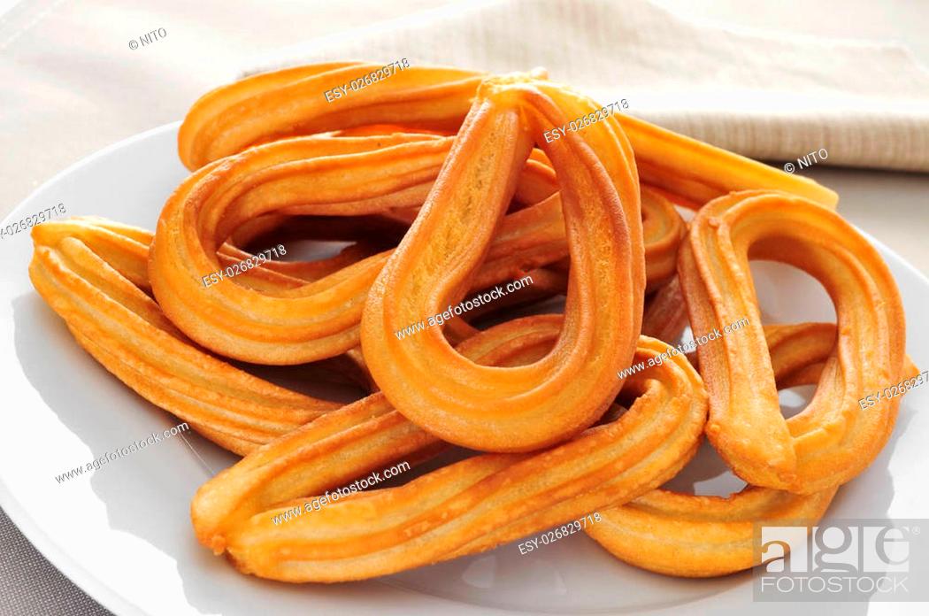 Stock Photo: closeup of a plate with some churros typical of Spain.