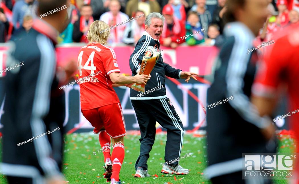 Stock Photo: Munich's Anatoli Timoschtschuk pours beer over the coach Jupp Heynckes after their team wins German Championship in the match FC Bayern Munich and FC Augsburg.