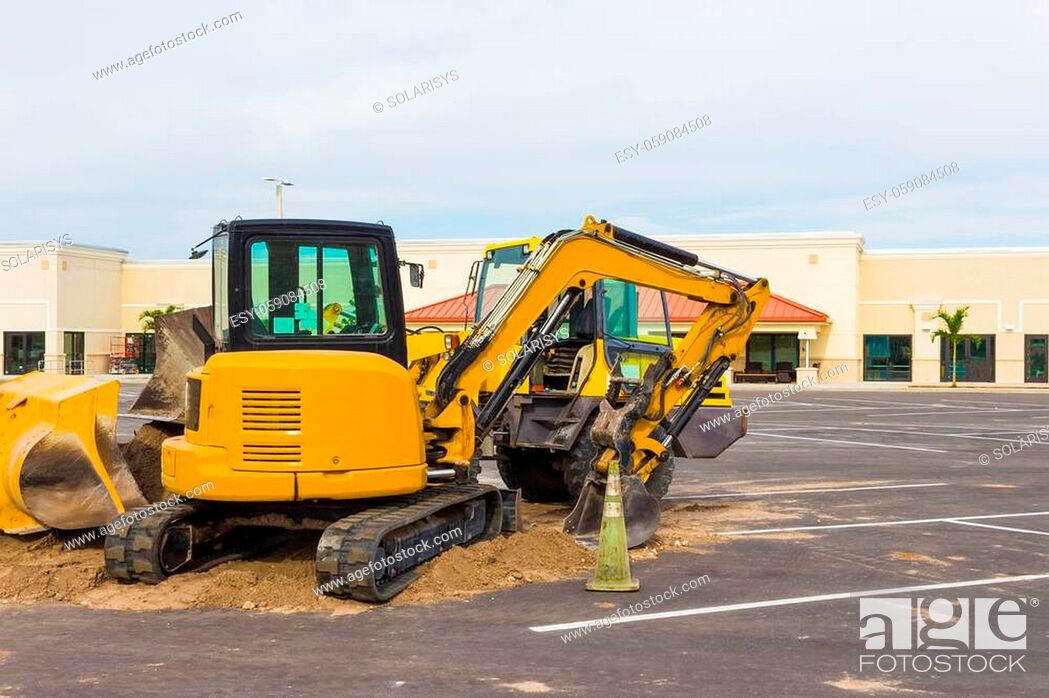 Stock Photo: Front end loader dumping stone and sand at at constraction site.