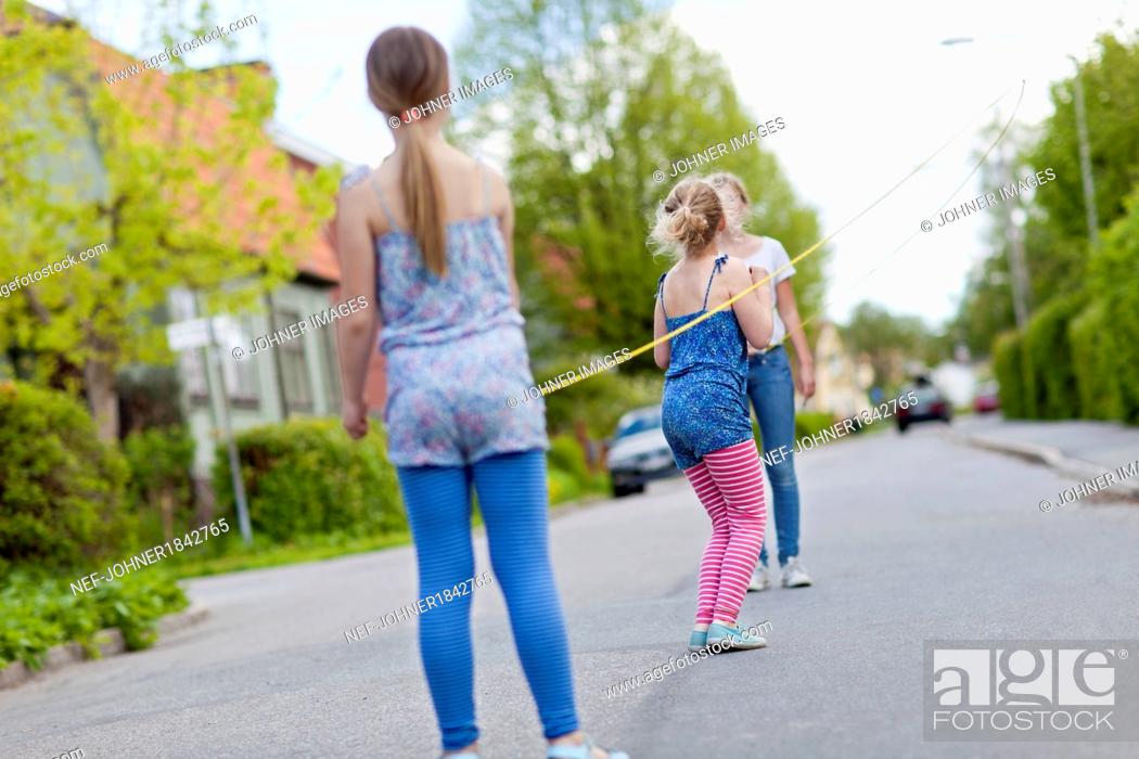 Stock Photo: Two girl standing, rear view.