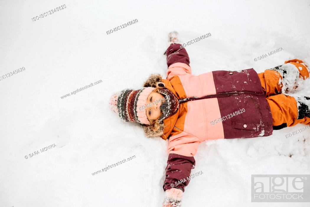 Stock Photo: Canada, Ontario, Girl (2-3) doing snow angels.