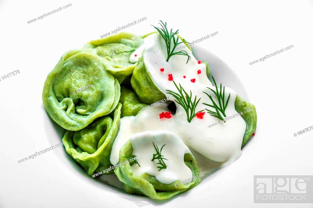Stock Photo: Ravioli pasta from green dough with mushroom stuffing, oil, parsley, vegetarian dish.