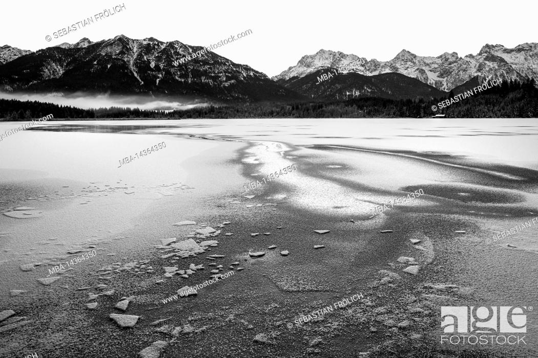 Stock Photo: The frozen Barmsee near Krün in the Bavarian foothills of the Alps. In the foreground a track in the ice, in the background forest.