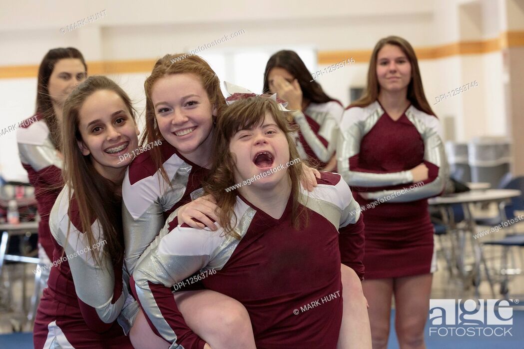 Stock Photo: Group of cheerleading girls having fun, one with Down Syndrome.