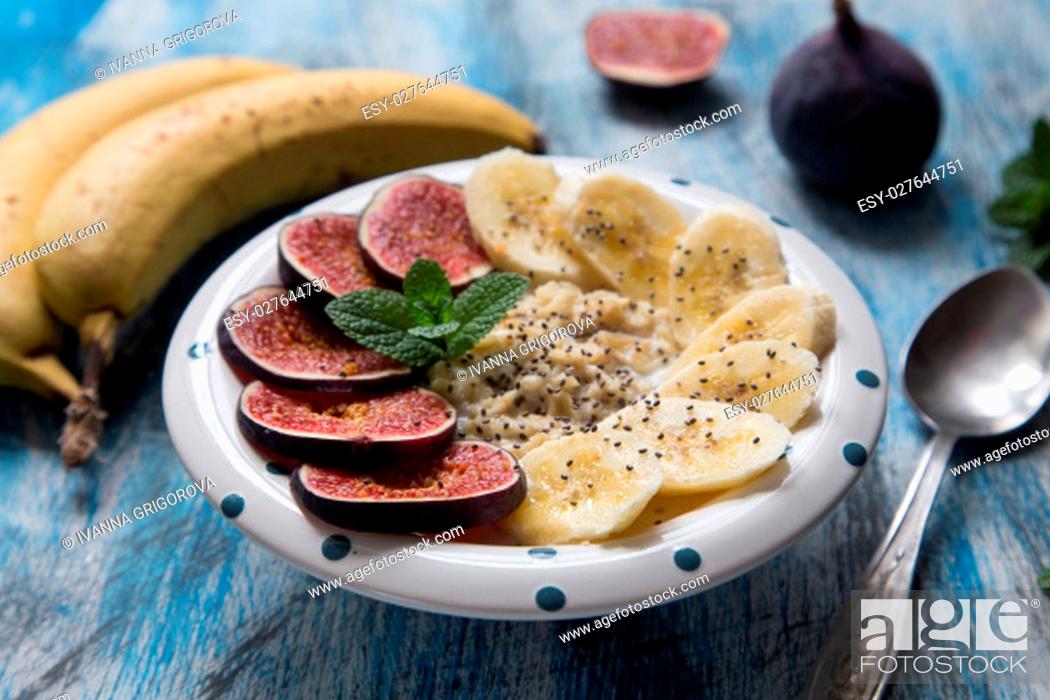 Stock Photo: healthy breakfast: oatmeal with fresh figs, bananas, coconut milk and chia seeds.