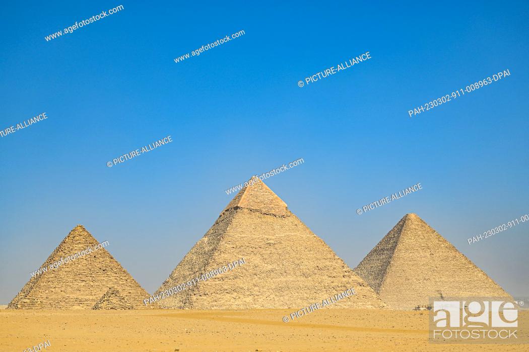 Stock Photo: 02 March 2023, Egypt, Giza: A general view of the Pyramids of Giza (L-R) Menkaure, Khafre, and Khufu, during the results announcement of the ScanPyramids.