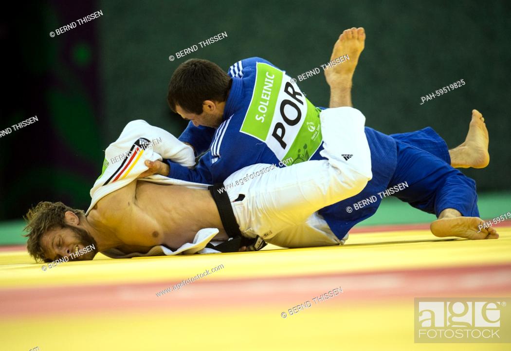 Stock Photo: Germanys Sebastian Seidl (white) competes with Sergiu Oleinic of Portugal in the Men's -66kg Judo Bronze Medal Final B at the Baku 2015 European Games in Heydar.