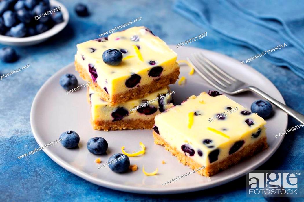 Stock Photo: Blueberry bars, cake, cheesecake on a grey plate on blue stone background.