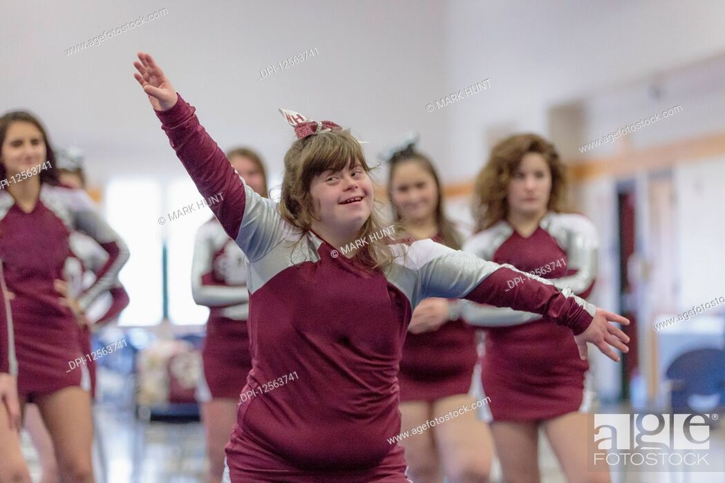 Stock Photo: Cheerleader with Down Syndrome cheering with her friends.
