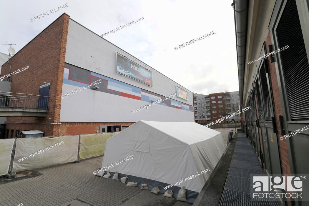 Stock Photo: 19 March 2020, Mecklenburg-Western Pomerania, Rostock: A large tent as a possible second Corona test centre is located behind the town hall.