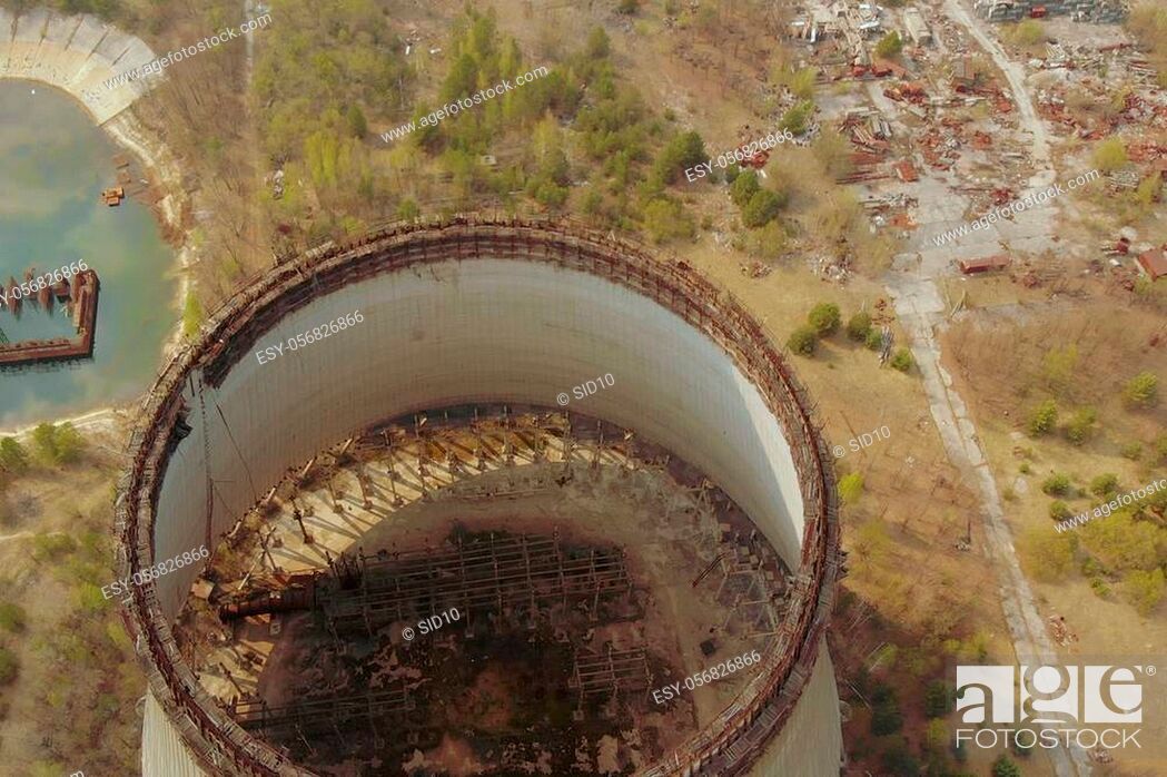 Stock Photo: Flying over the cooling tower near the Chernobyl nuclear power plant. Territory near the Chernobyl NPP. Piles of metal and equipment contaminated by radiation.