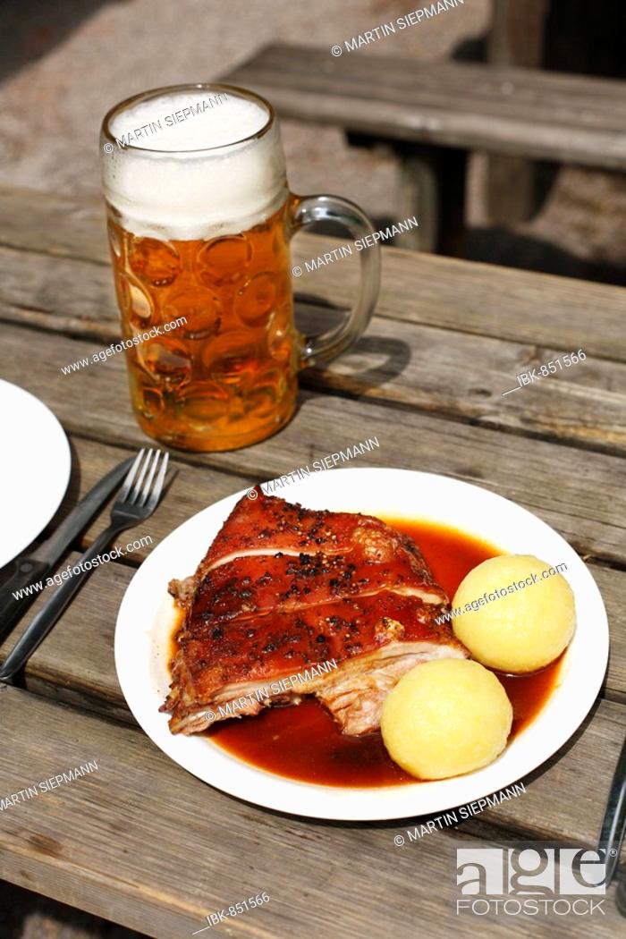 Stock Photo: Suckling Pig with Dumplings and a mass of beer served in a beer garden in Taxisgarten, Munich, Bavaria, Germany, Europe.