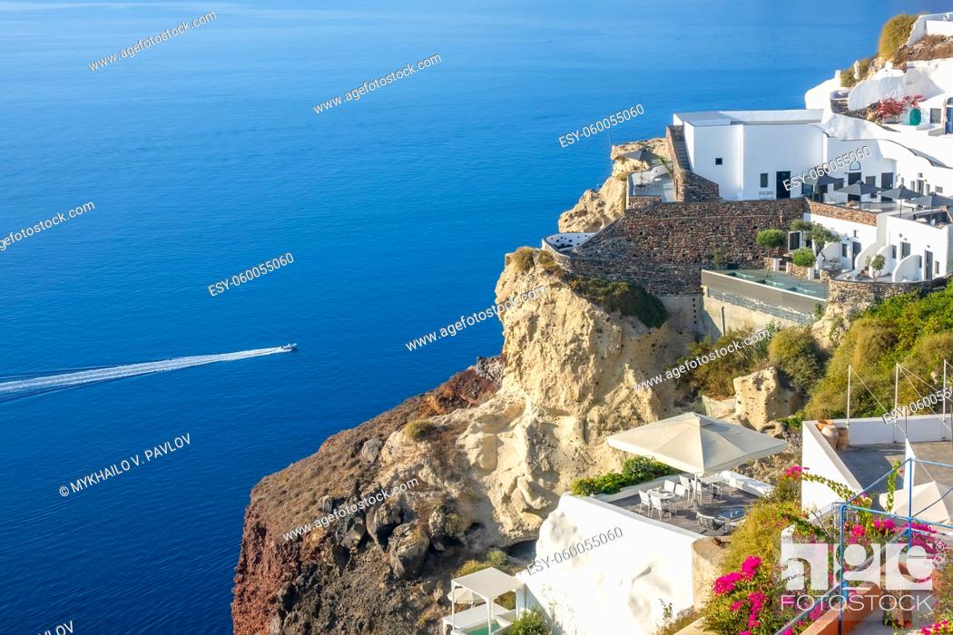 Stock Photo: Greece. Sunny summer day in Santorini. Buildings and terraces with flowers on the caldera with seaview.