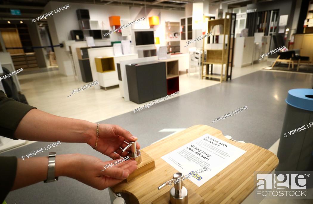 Stock Photo: Illustration picture shows a person demonstrating the use of a bottle of disinfecting liquid at the Anderlecht branch of the Ikea furniture stores.