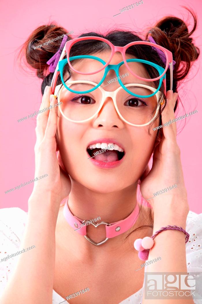 Stock Photo: Young girl with a pair of glasses.