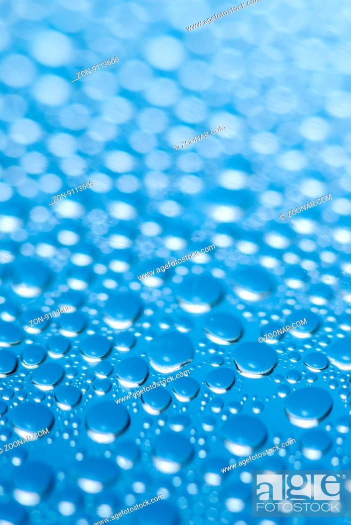 Stock Photo: close-up of water drops on the blue background.