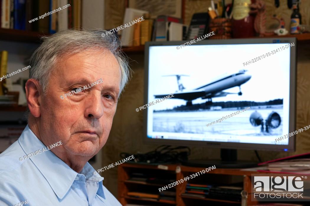 Stock Photo: 02 August 2022, Brandenburg, Wildau: Jörn Lehweß-Litzmann sits in his office in front of a computer display showing an identical IL-62 landing.