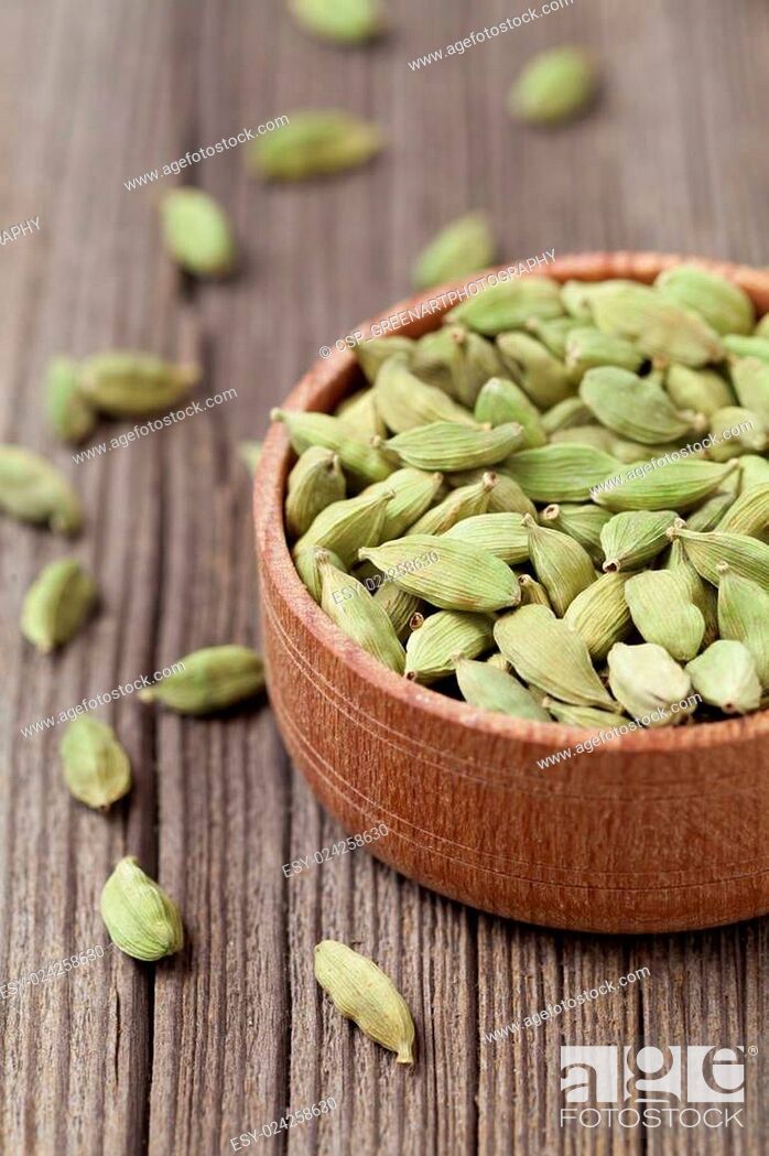 Stock Photo: Green cardamom ayurveda asian aroma spice in a wooden bowl on vi.