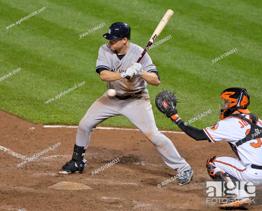 Stock Photo: New York Yankees third baseman Chase Headley (12) watches a pitch go by as he bats in the eighth inning against the Baltimore Orioles at Oriole Park at Camden.