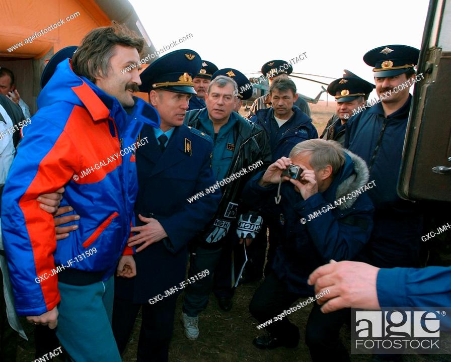 Stock Photo: Cosmonaut Alexander Y. Kaleri (left), Soyuz flight engineer representing Russia's Federal Space Agency, is helped from the medical tent to the all terrain.