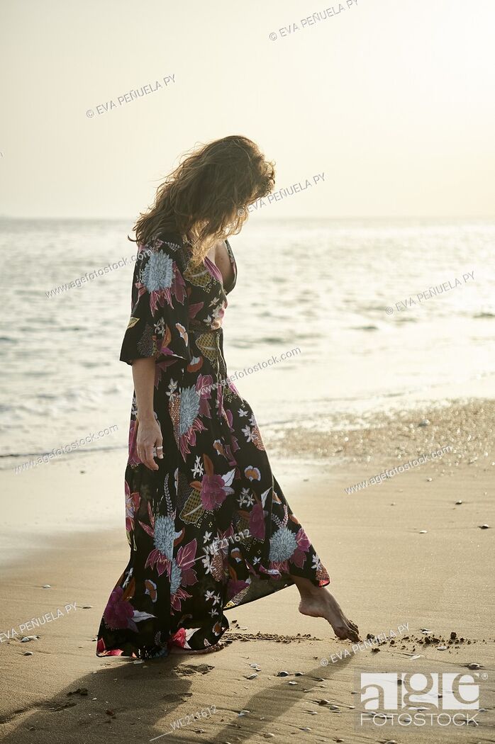 Stock Photo: mature woman enjoying different moments on the beach.