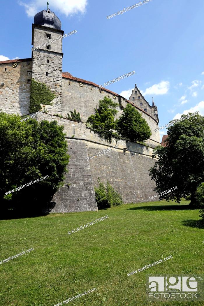 Stock Photo: The Veste Coburg, also known as the ""Frankish Crown"", rises high above the city with its huge walls and towers. In 1056 the fortress was first mentioned as.