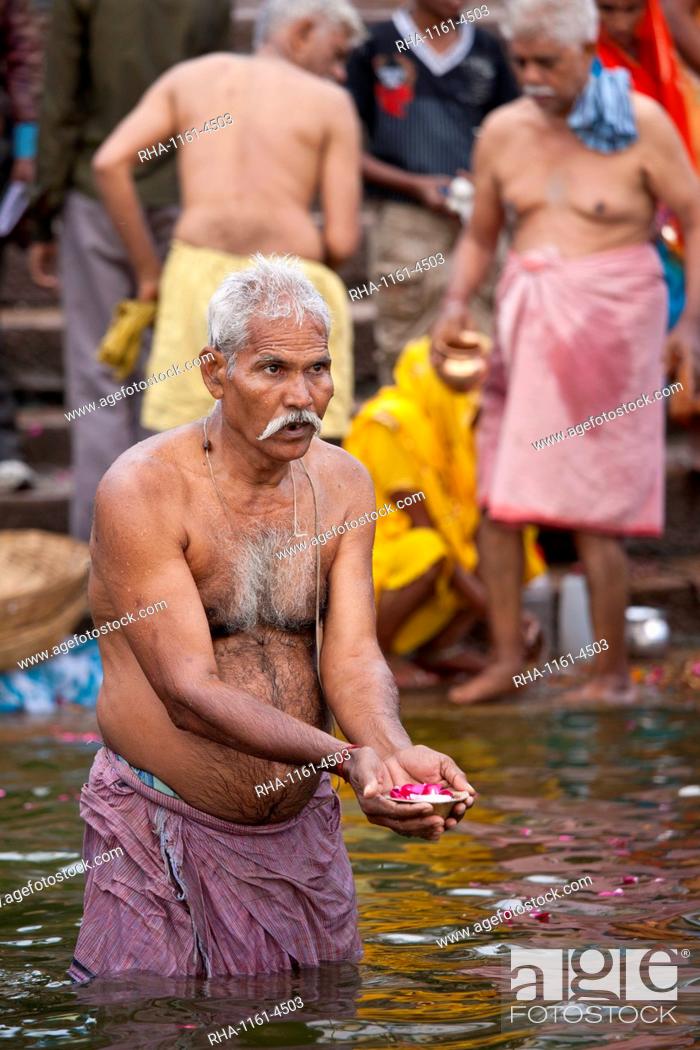 Stock Photo: Indian Hindu pilgrims bathing in The Ganges River at Dashashwamedh Ghat in Holy City of Varanasi, Benares, India.