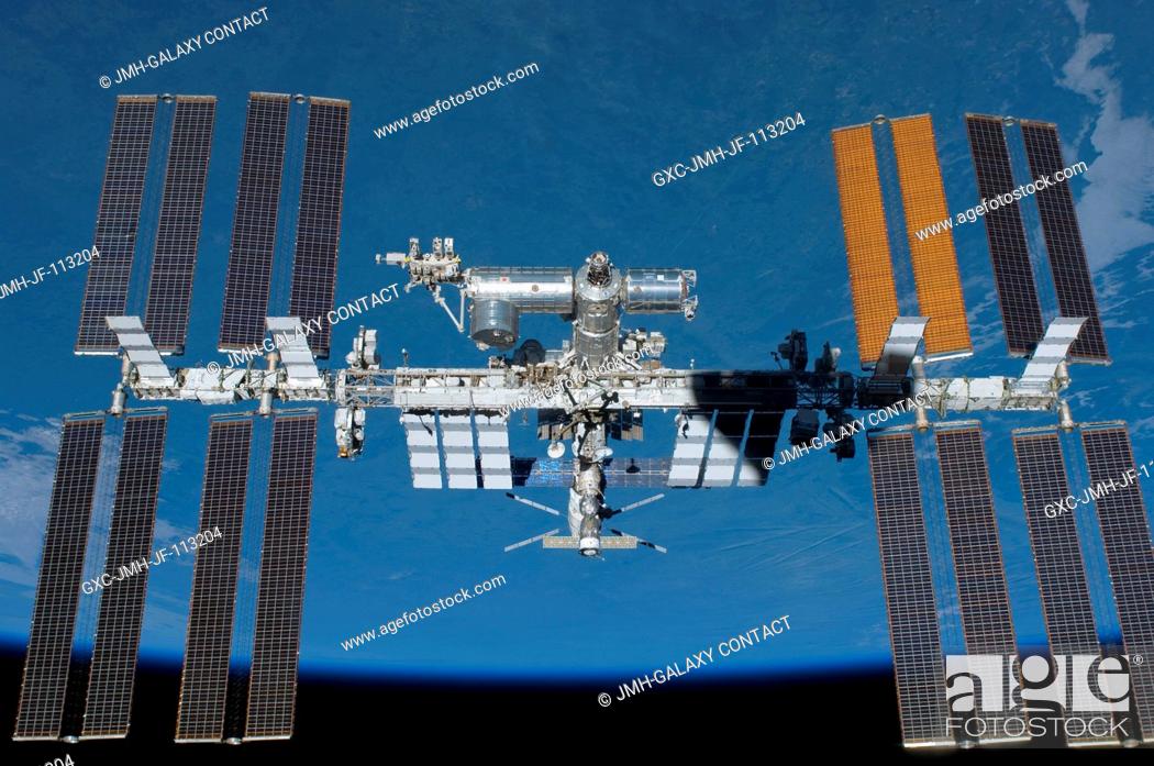 Stock Photo: Backdropped by Earth's horizon and the blackness of space, the International Space Station is featured in this image photographed by an STS-134 crew member on.