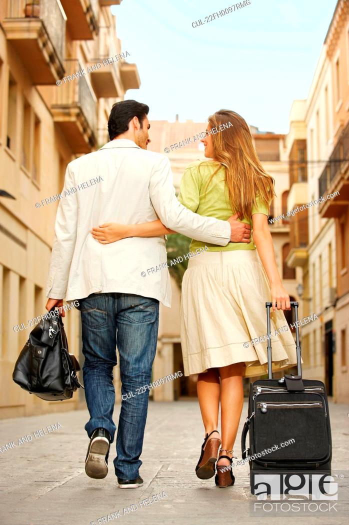 Stock Photo: Couple walking with luggage.